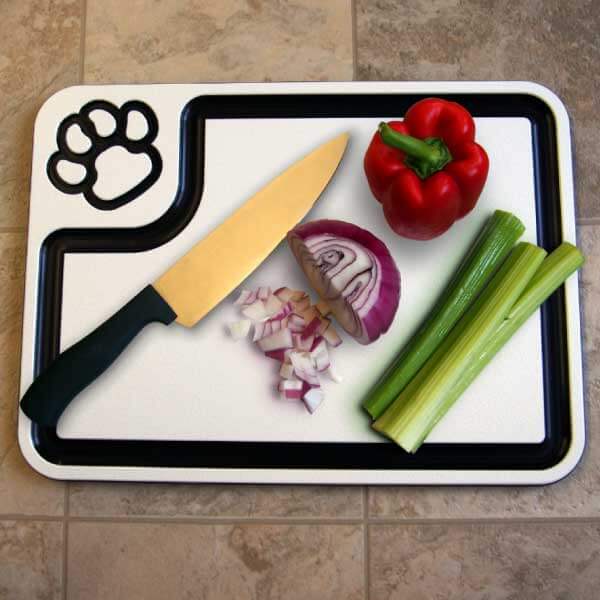 White paw-print cutting board in use.